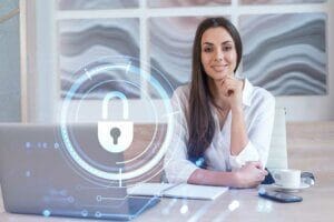 Woman at a desk with a digital lock icon.