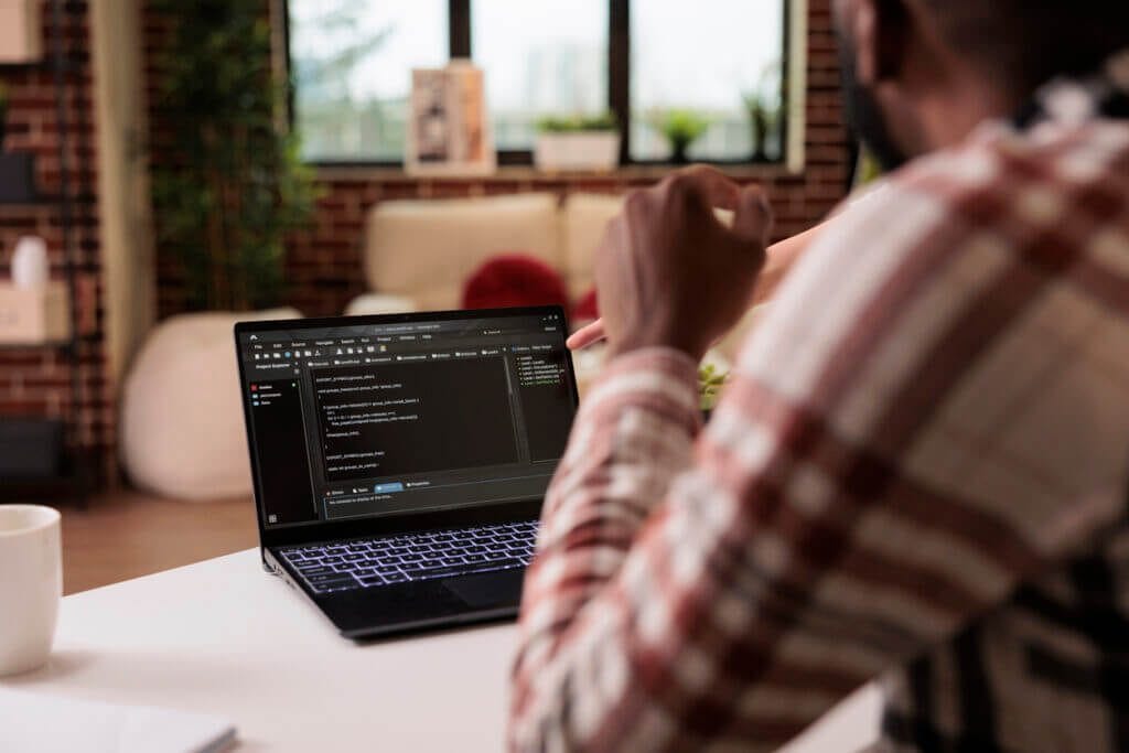 Employee working on email from a small laptop.