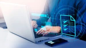 Employee working on network/IT projects from laptop.