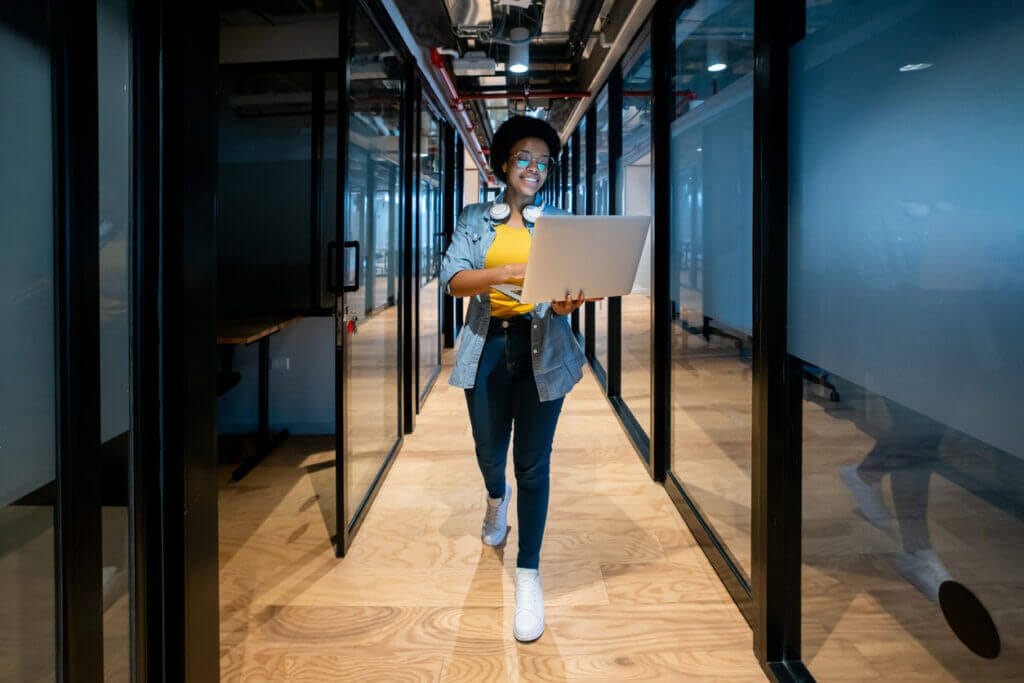 IT employee walking through network/IT closet.