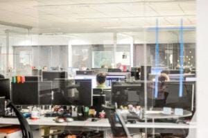 Cybersecurity awareness training in a glass office.