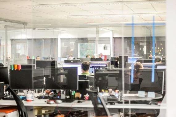 Cybersecurity awareness training in a glass office.
