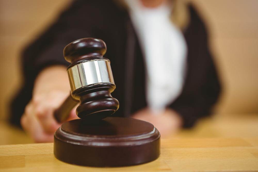 Woman holding gavel.