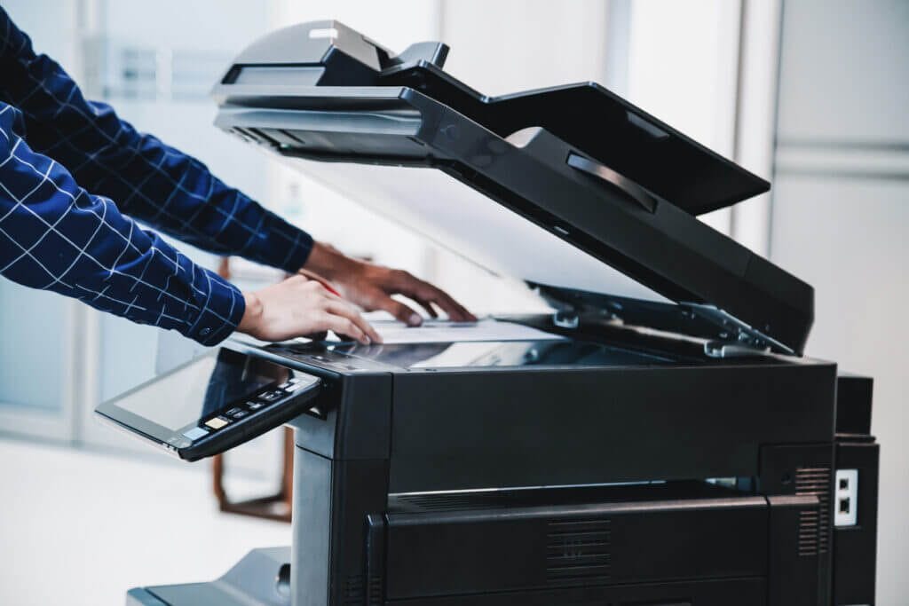 Employee making a photo copy in a printer.