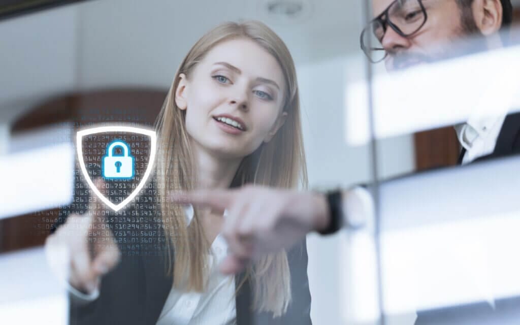 Employees in a high tech environment reviewing cyber security solutions.
