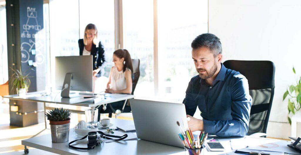 Co-workers sitting in a bright and airy office.