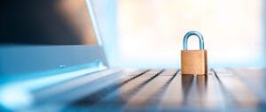 Lock sitting on laptop computer.