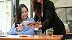 Professional women reviewing items on an ipad.