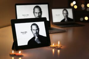 Pictures of Steve Jobs on ipads surrounded by candles.