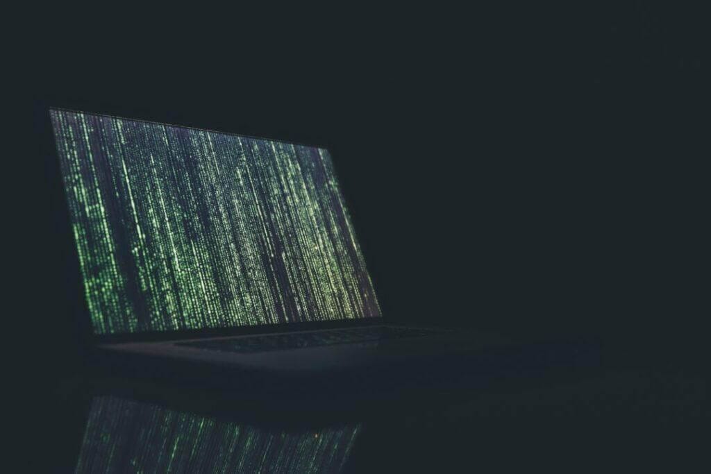 Lines of code streaming down on a laptop computer.