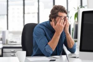 Stressed businessman working at an office.