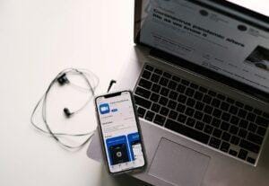ZoomMeeting app loaded on a mobile device along with a laptop.