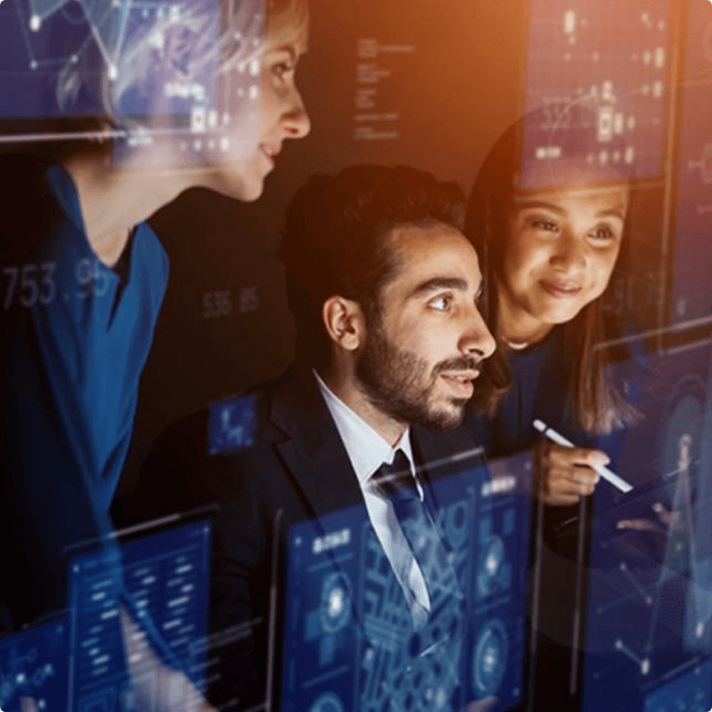 Employees in a meeting reviewing cybersecurity business projects.