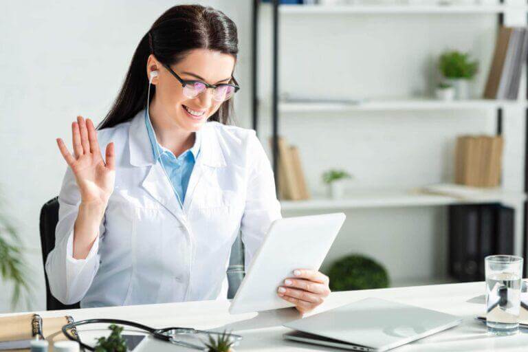 A woman on a telehealth video call via a tablet.