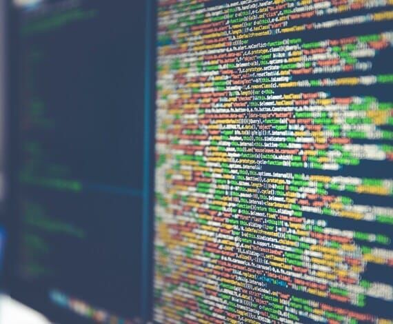 Dual monitors with coding.