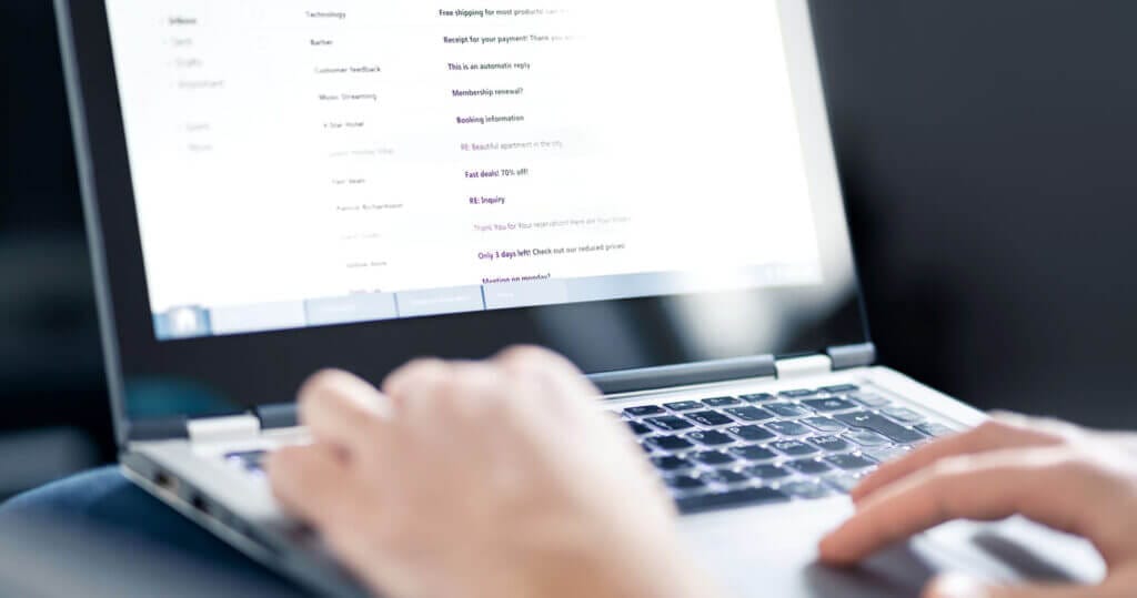 Hands typing on computer.