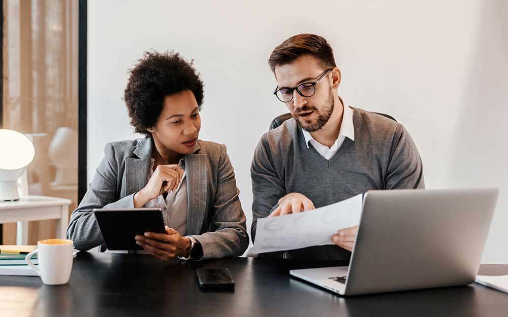 Two business people working on cybersecurity projects